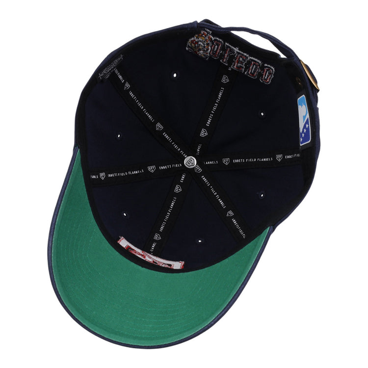 Inside view of the Ebbets Field Toledo Mud Hens MiLB Dad Ballcap shows a navy blue interior, green underbill, white rivets, black taping with white logos/text, and a white and blue logo patch.