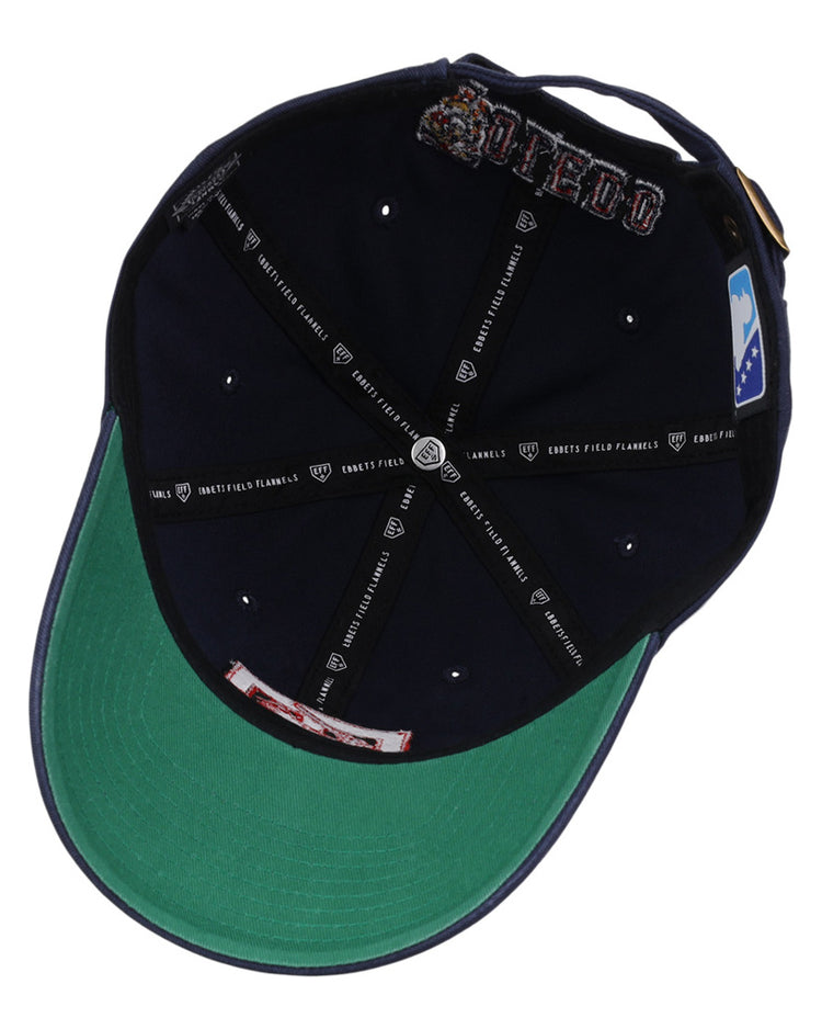 Inside view of the Ebbets Field Toledo Mud Hens MiLB Dad Ballcap shows a navy blue interior, green underbill, white rivets, black taping with white logos/text, and a white and blue logo patch.