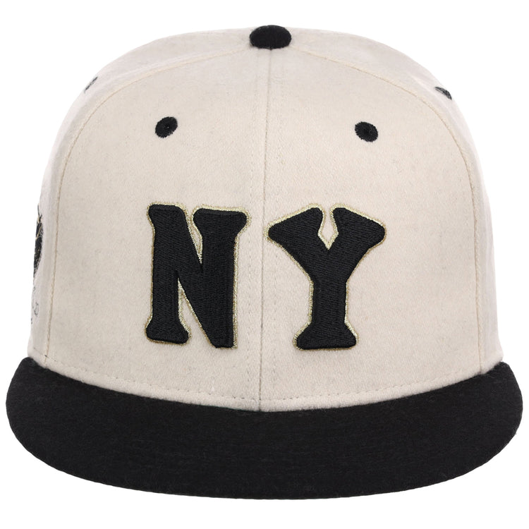 The Ebbets Field New York Black Yankees NLB Ballpark Fitted Ballcap features a cream color, a black brim, and large black NY lettering embroidered on the front.
