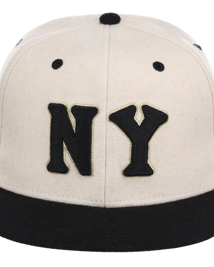 The Ebbets Field New York Black Yankees NLB Ballpark Fitted Ballcap features a cream color, a black brim, and large black NY lettering embroidered on the front.
