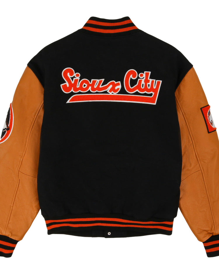 The Sioux City Ghosts NLB DNA Varsity Jacket by Ebbets Field features tan leather sleeves, a black wool body, black/red striped trim, sleeve patches, and bold red-and-white 