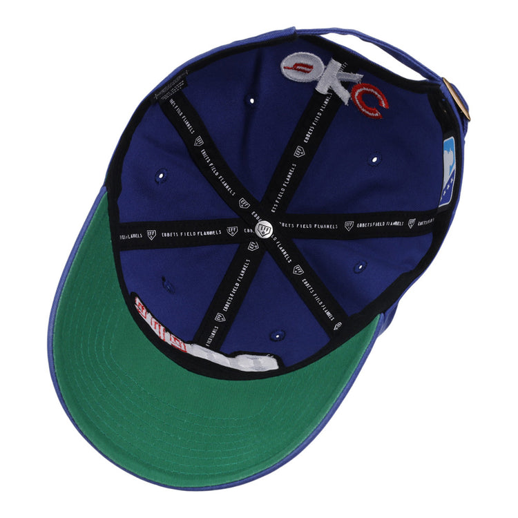 The underside of the Ebbets Field Oklahoma City 89Ers MiLB Dad Ballcap shows a green bill, black interior lining, sewn labels, embroidered 