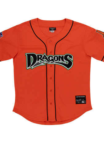 The Ebbets Field Dayton Dragons MiLB Button Down Jersey features a bright orange body with black trim, 