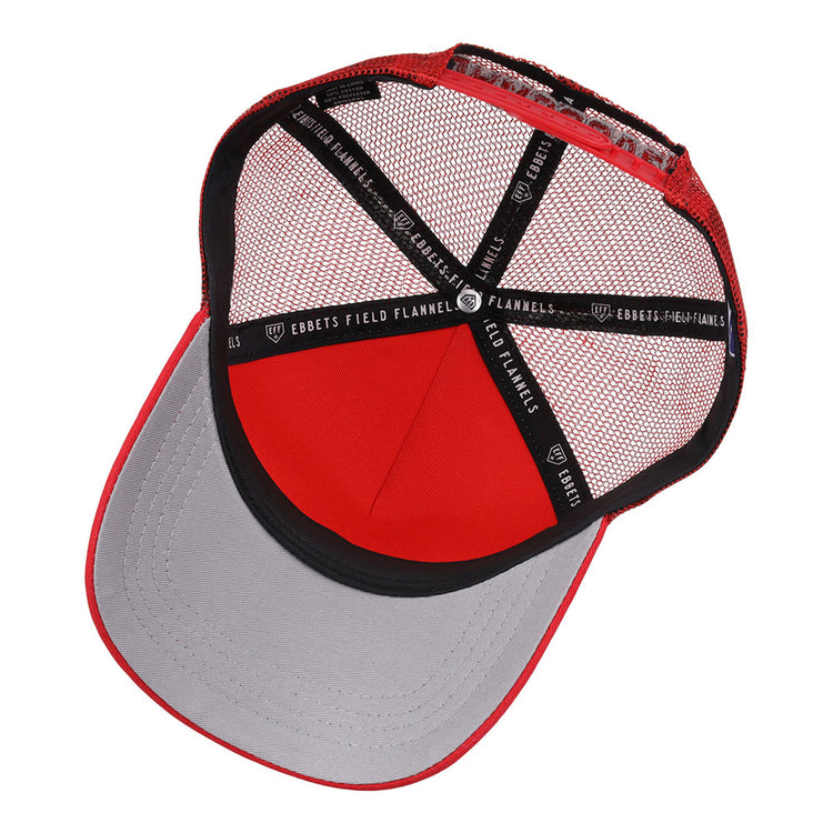 A top-down view of the inside of a red and gray Vancouver Canadians MiLB Trucker Ballcap by Ebbets Field, featuring black interior linings with repeated white “EBBETS FIELD FLANNELS” text.