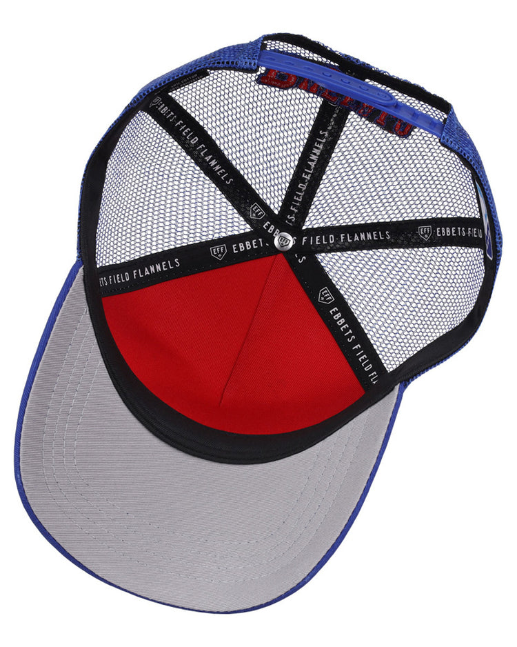 The Buffalo Bisons MiLB Trucker Ballcap by Ebbets Field features a blue crown, grey brim, red front panel, black mesh back, and interior seams lined with Ebbets Field branded tape.