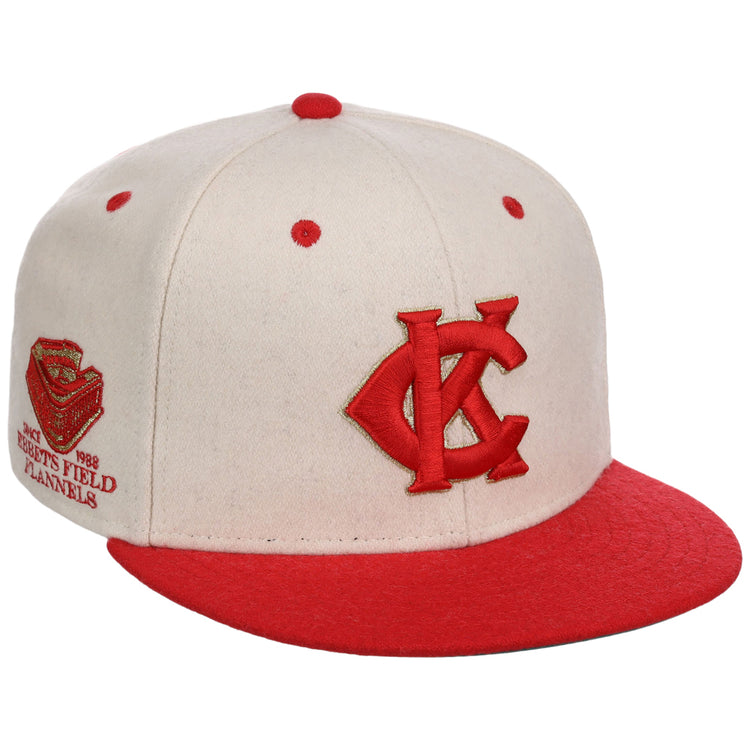 The Ebbets Field Kansas City Monarchs NLB Ballpark Fitted Ballcap is a cream cap with red accents, a red KC logo on the front, an embroidered side patch, and red brim and top button.