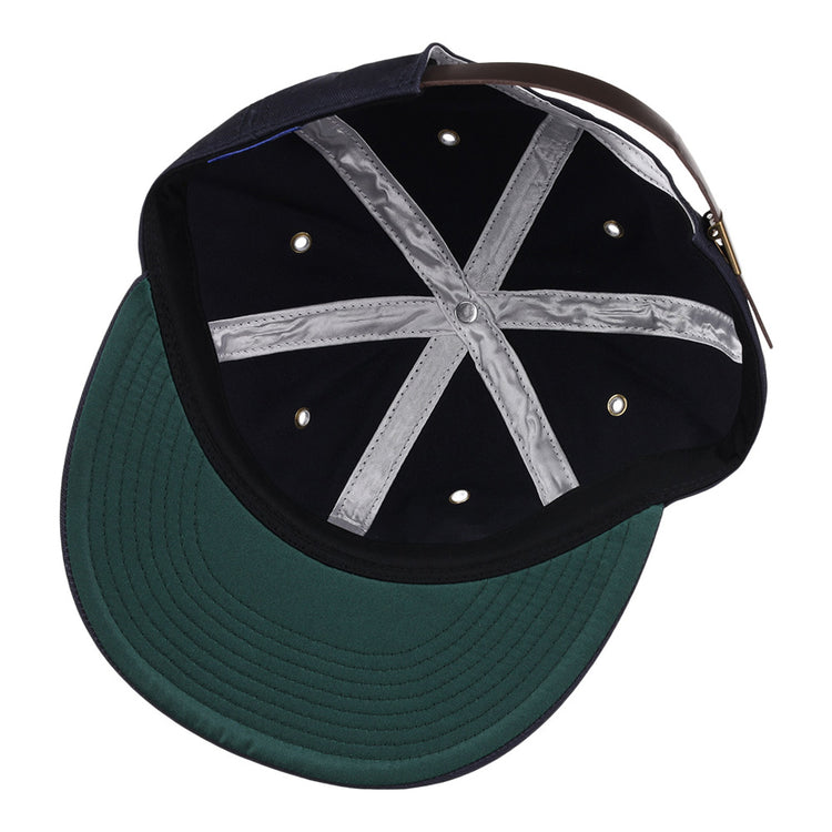 The inside view of the Ebbets Field Binghamton Triplets MiLB Cotton Ballcap features a black crown, green brim, silver cross-shaped seam tape, six ventilation holes, and an adjustable brown leather strap with metal buckle.