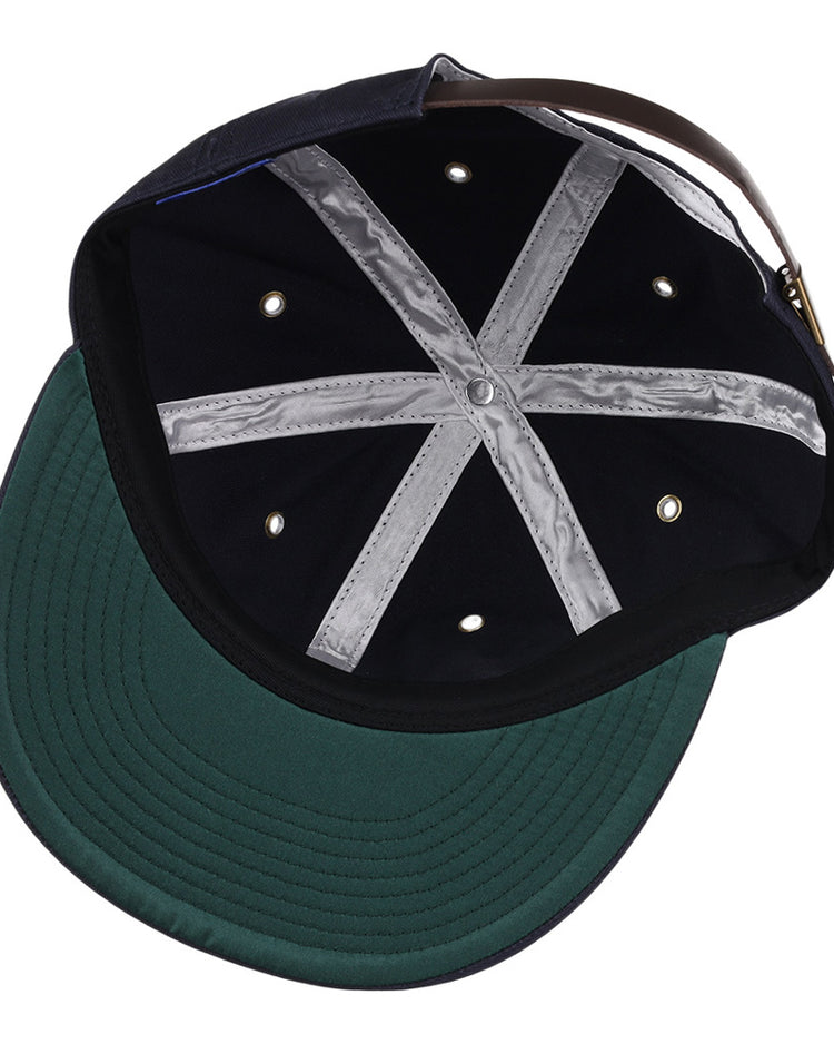 The inside view of the Ebbets Field Binghamton Triplets MiLB Cotton Ballcap features a black crown, green brim, silver cross-shaped seam tape, six ventilation holes, and an adjustable brown leather strap with metal buckle.
