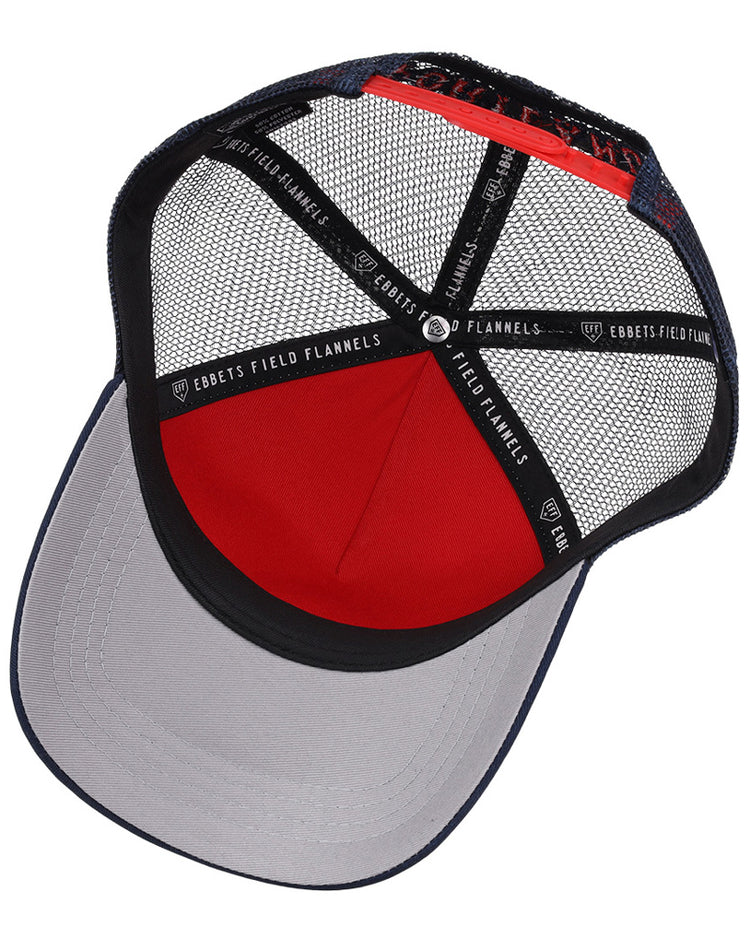 Inside the Portland Sea Dogs MiLB Trucker Ballcap by Ebbets Field, black mesh panels, a red fabric section, a gray brim, and black strips labeled Ebbets Field are visible.