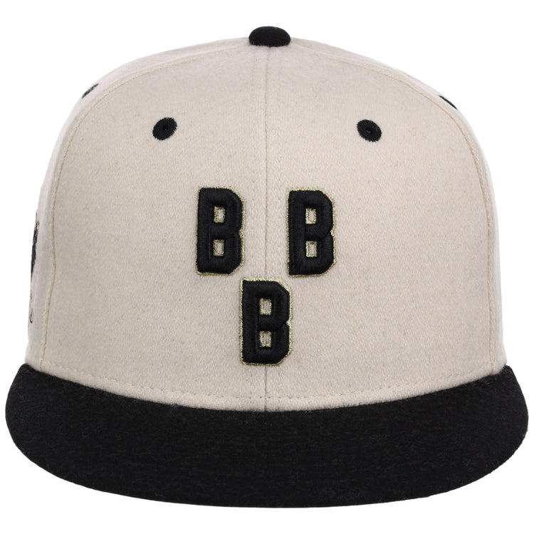 The Ebbets Field Birmingham Black Barons NLB Ballpark Fitted Ballcap is beige with a black brim and button, featuring three bold, black Bs arranged vertically on the front.