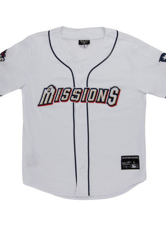 The Ebbets Field San Antonio Missions MiLB Button Down Jersey features “Missions” across the chest, navy blue trim, a Texas flag patch on the left sleeve, and team and brand tags near the bottom hem.