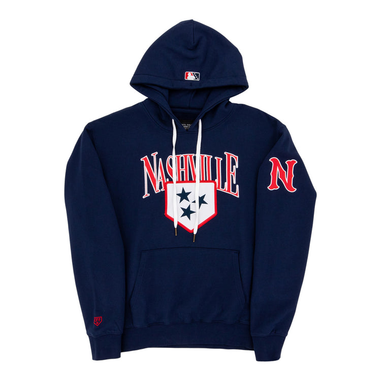 The Ebbets Field Nashville Sounds MiLB Cotton Hooded Sweatshirt is a navy blue hoodie with white drawstrings, Nashville in bold white and red letters, a three-star shield on the chest, red N on the sleeve, and an MLB logo on the hood.
