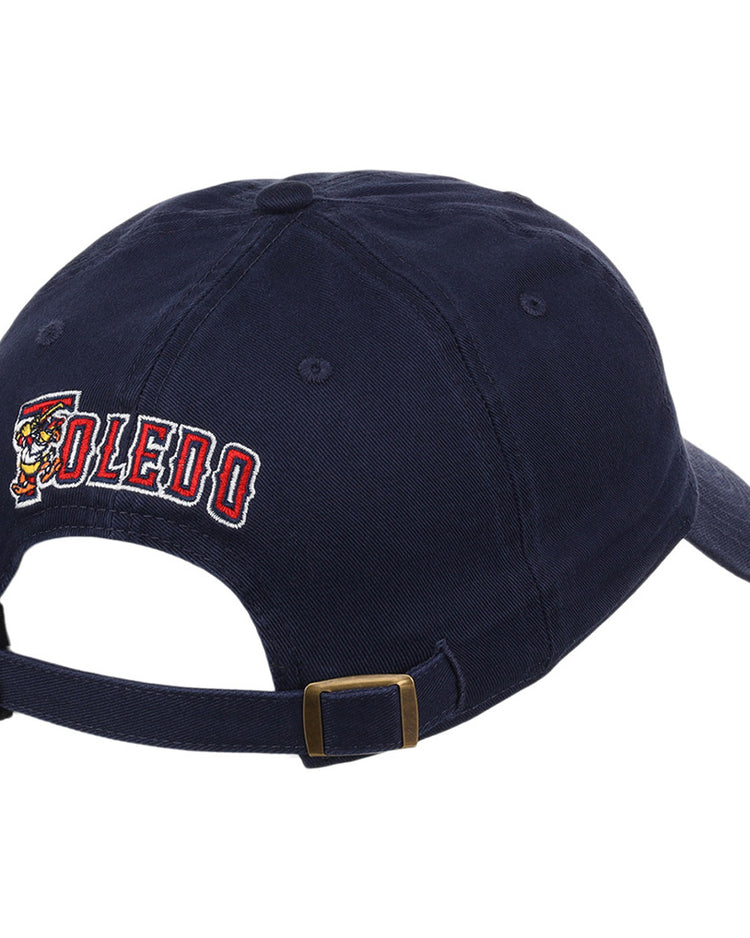 The Ebbets Field Toledo Mud Hens MiLB Dad Ballcap is a navy blue adjustable cap with brass buckle, TOLEDO embroidered in red and white on the back, and a cartoon mascot on the left of the text.