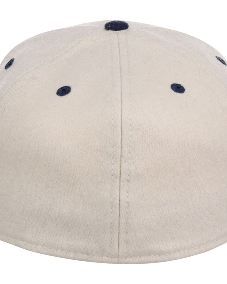 The Seattle Steelheads NLB Ballpark Fitted Ballcap by Ebbets Field is a beige cap seen from the back, with dark blue stitched eyelets and a center button on top.