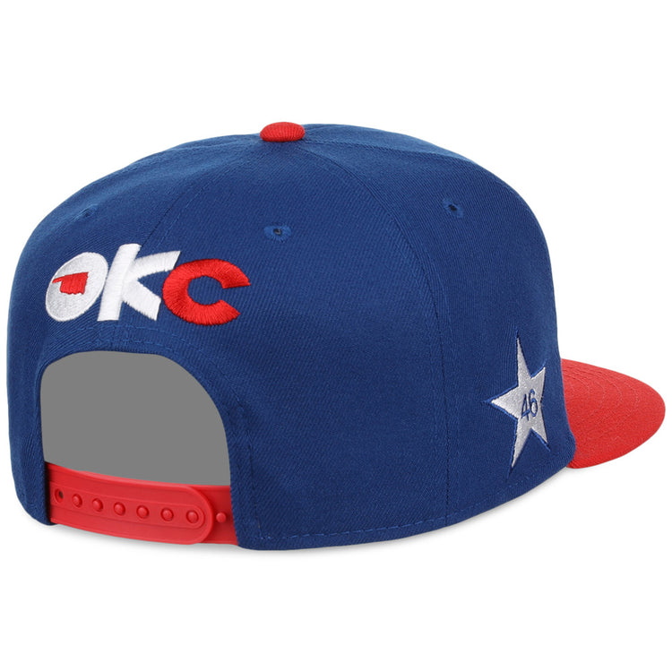 The Ebbets Field Oklahoma City Dodgers MiLB Two Tone Snapback Ballcap is blue with a red brim and button, OKC text on the back, a white star with 46 on the side, and an adjustable red strap.