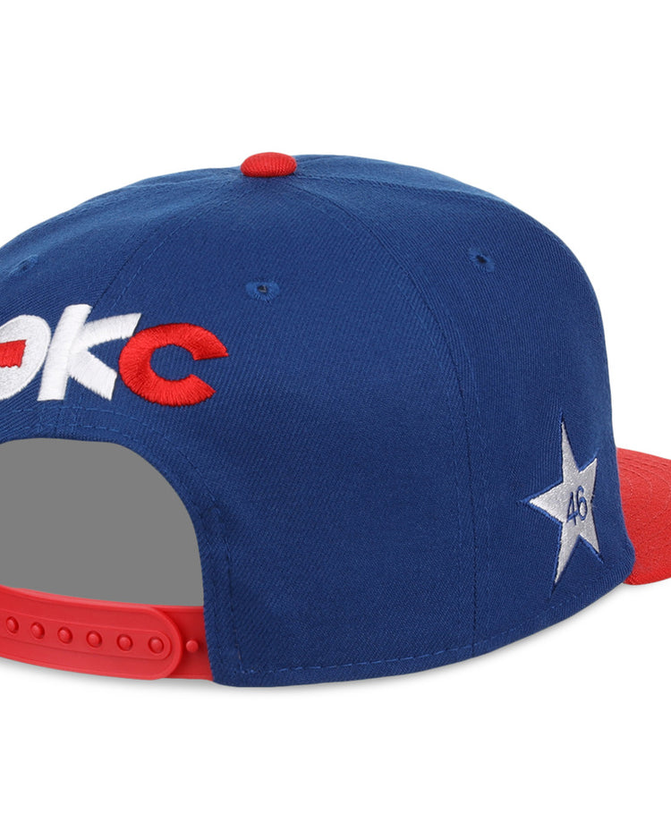 The Ebbets Field Oklahoma City Dodgers MiLB Two Tone Snapback Ballcap is blue with a red brim and button, OKC text on the back, a white star with 46 on the side, and an adjustable red strap.