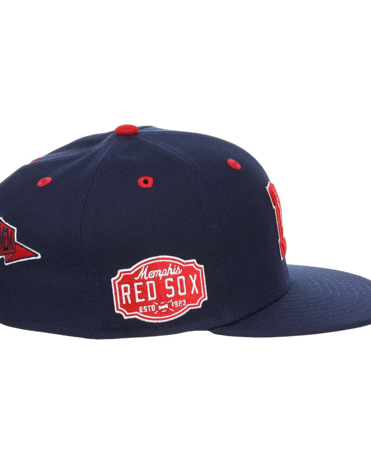 The Memphis Red Sox NLB Varsity Fitted Ballcap by Ebbets Field is a navy blue flat-brim hat with red and white embroidered patches, including 