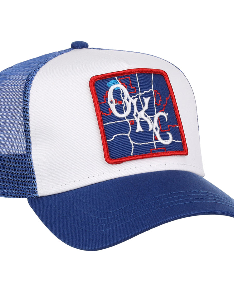 The Ebbets Field Oklahoma City Dodgers MiLB Trucker Ballcap is a blue and white mesh-back hat with a front patch showing a blue map design, OKC in white script, and a red border.