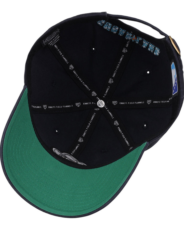 A look inside the Ebbets Field Sugarland Space Cowboys MiLB Dad Ballcap shows a green underbrim, black interior, and inner seams with white text and graphics.
