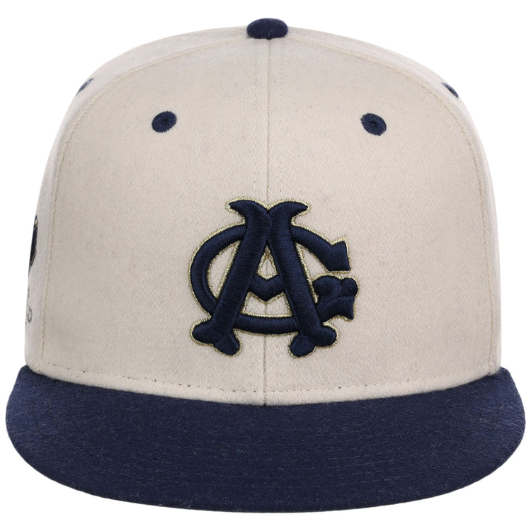 The Ebbets Field Chicago American Giants NLB Ballpark Fitted Ballcap features a cream crown, navy brim and button, and a dark blue interlocking CA logo outlined in gold on the front.