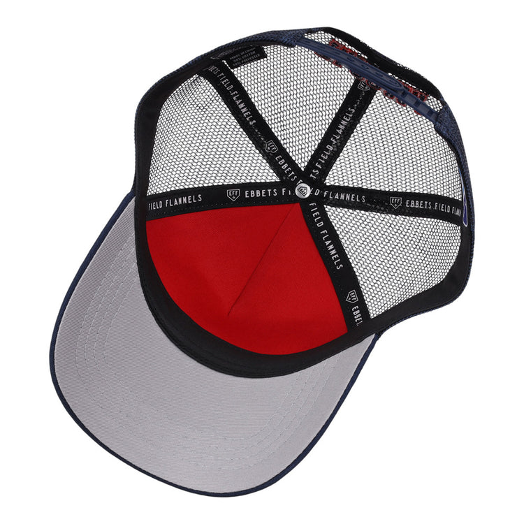 A look inside the Tacoma Rainers MiLB Trucker Ballcap by Ebbets Field shows a gray brim, red front panel, black mesh back, and black inner bands marked Ebbets Field.