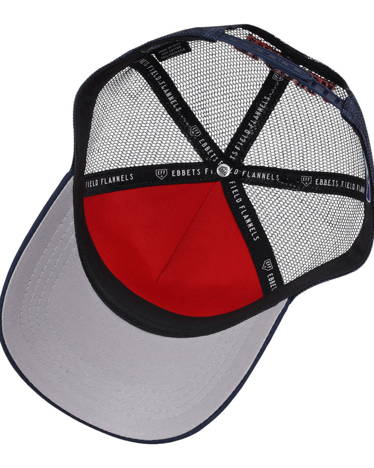 A look inside the Tacoma Rainers MiLB Trucker Ballcap by Ebbets Field shows a gray brim, red front panel, black mesh back, and black inner bands marked Ebbets Field.