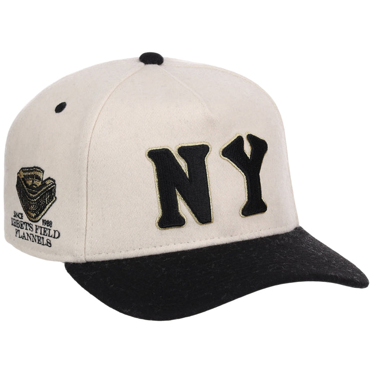 The Ebbets Field New York Black Yankees NLB Ballpark A-Frame Ballcap features a cream and black design with bold black NY letters on the front and a side patch reading Negro Leagues 1946.