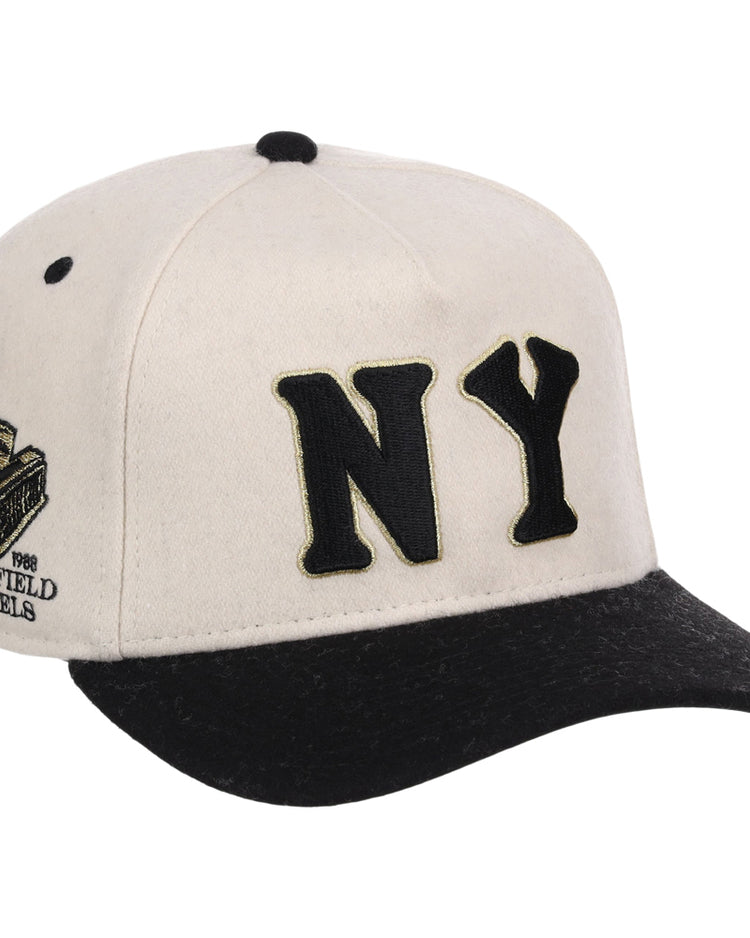 The Ebbets Field New York Black Yankees NLB Ballpark A-Frame Ballcap features a cream and black design with bold black NY letters on the front and a side patch reading Negro Leagues 1946.