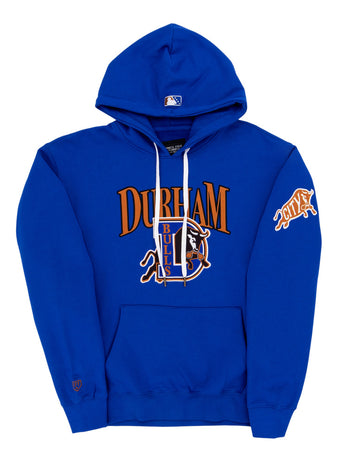 The Durham Bulls MiLB Cotton Hooded Sweatshirt by Ebbets Field features DURHAM BULLS and a bull logo on the front, an orange CITY patch on the sleeve, kangaroo pocket, drawstrings, and an MLB logo on the hood.