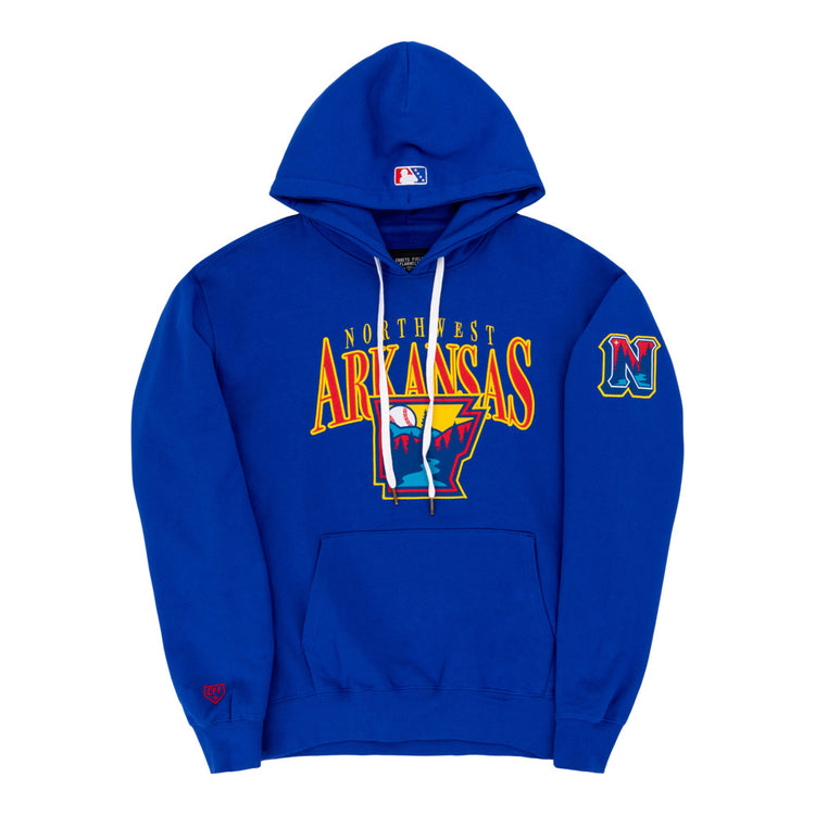 The Ebbets Field Northwest Arkansas Naturals MiLB Cotton Hooded Sweatshirt is royal blue with an Arkansas outline and claw marks on the front, a stylized N logo, an embroidered N patch on the left sleeve, and a red logo on the right cuff.