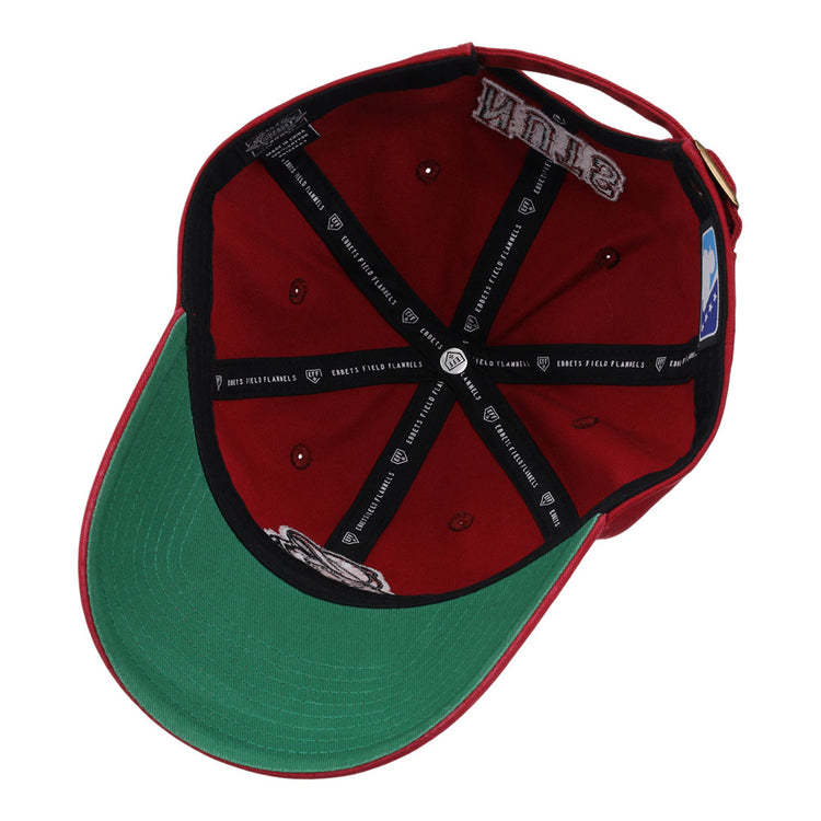 The Modesto Nuts MiLB Dad Ballcap by Ebbets Field is shown inside-out, featuring a green undervisor, black taping with white logos, a patch, and a blue and white MLB logo tag on the inner band.