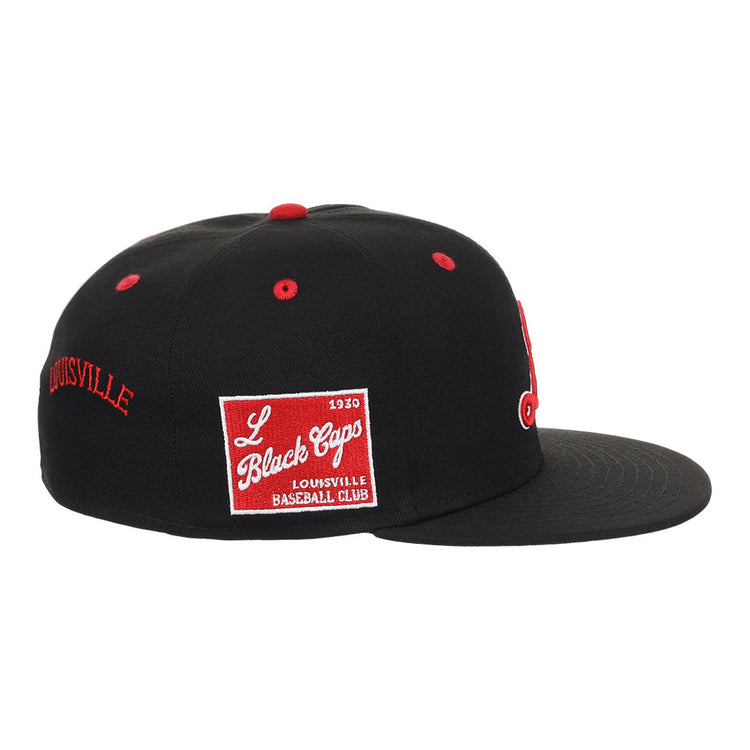 The Ebbets Field Louisville Black Caps NLB Varsity Fitted Ballcap is a black cap with red accents, a red and white “L Black Caps Louisville Baseball Club” patch on the side, and “LOUISVILLE” embroidered in red on the back.