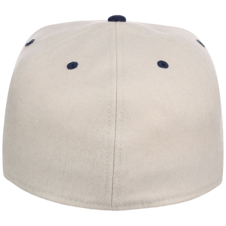 The Ebbets Field Homestead Grays NLB Ballpark Fitted Ballcap is beige, shown from the back with six navy blue eyelets and a matching navy button on top.