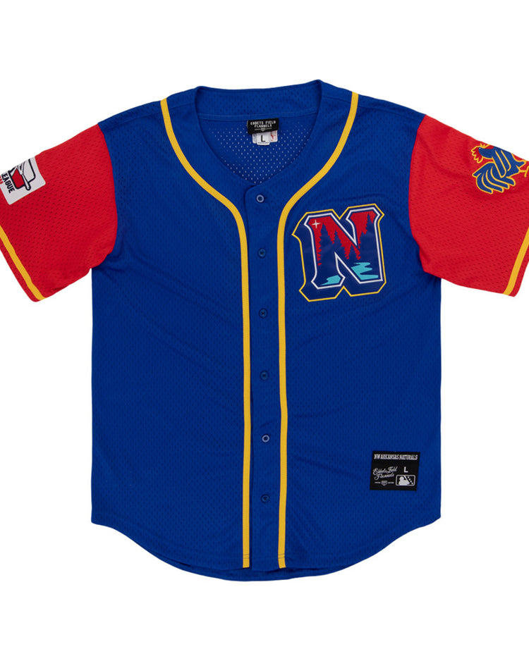 The Ebbets Field Northwest Arkansas Naturals MiLB Button Down Jersey features blue fabric, yellow trim, red sleeves, a left-sleeve patch, lion logo on the right sleeve, and a chest 