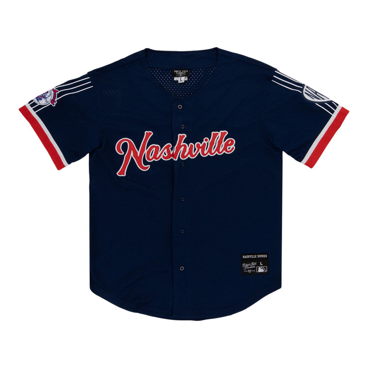 The Ebbets Field Nashville Sounds MiLB Button Down Jersey features navy blue fabric with red and white accents, 
