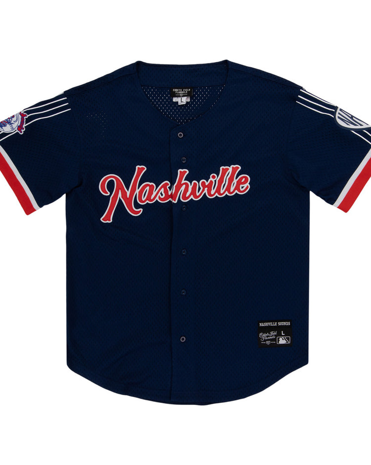 The Ebbets Field Nashville Sounds MiLB Button Down Jersey features navy blue fabric with red and white accents, 