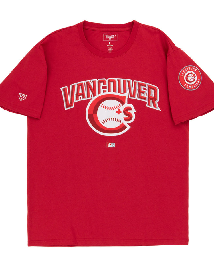 The Vancouver Canadians MiLB Fashion Cotton Short Sleeve Tee by Ebbets Field features a red design with a Vancouver logo and baseball graphic on the chest, plus a circular Vancouver Canadians patch on the left sleeve.