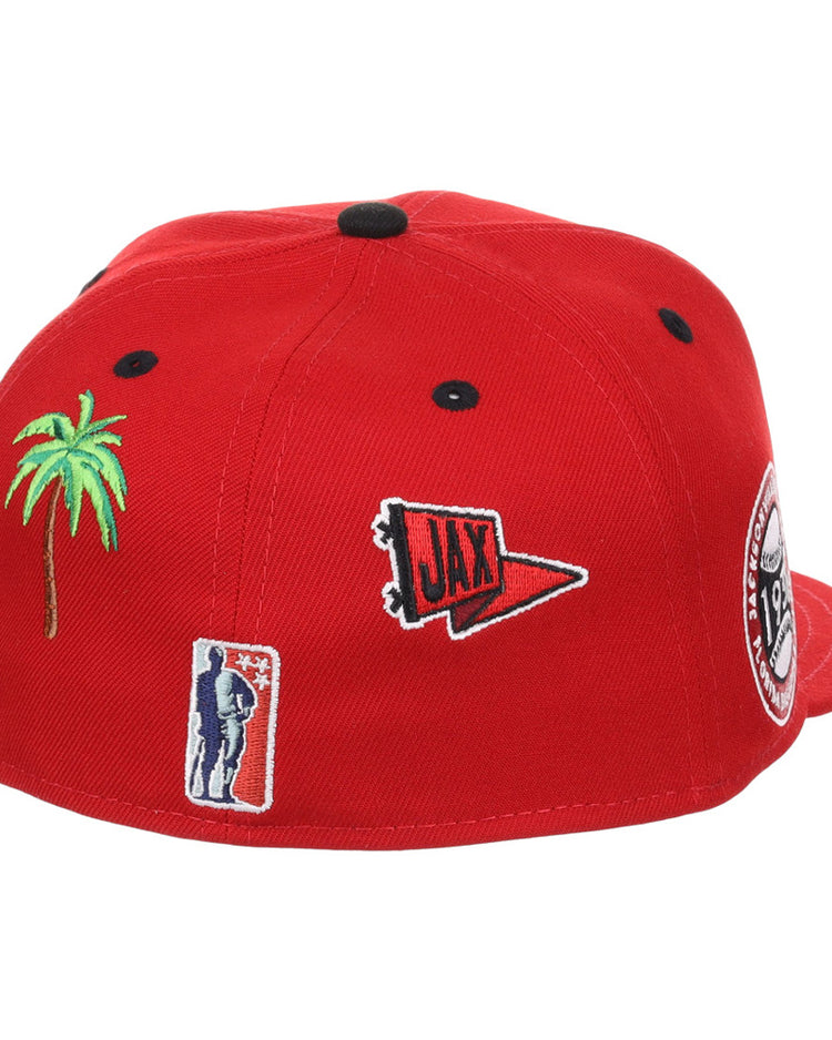 The Ebbets Field Jacksonville Red Caps NLB Varsity Fitted Ballcap is a red hat featuring embroidered patches: a green palm tree, a red 