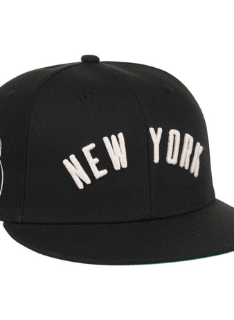 The Ebbets Field New York Black Yankees NLB Black/White Fitted Ballcap features NEW YORK embroidered in white on the front and a small white patch on the left side.