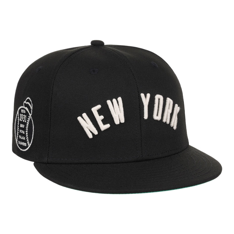 The Ebbets Field New York Black Yankees NLB Black/White Fitted Ballcap features NEW YORK embroidered in white on the front and a small white patch on the left side.