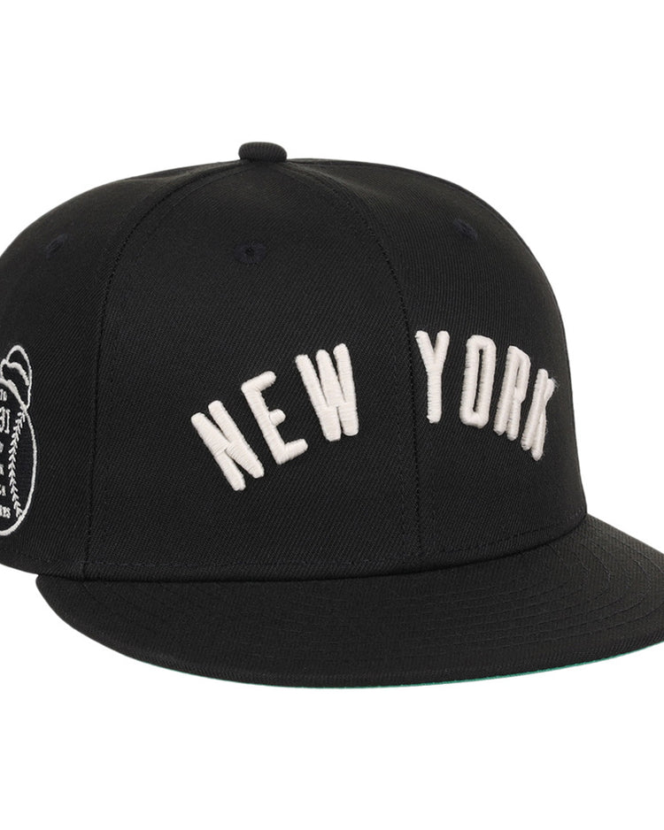The Ebbets Field New York Black Yankees NLB Black/White Fitted Ballcap features NEW YORK embroidered in white on the front and a small white patch on the left side.