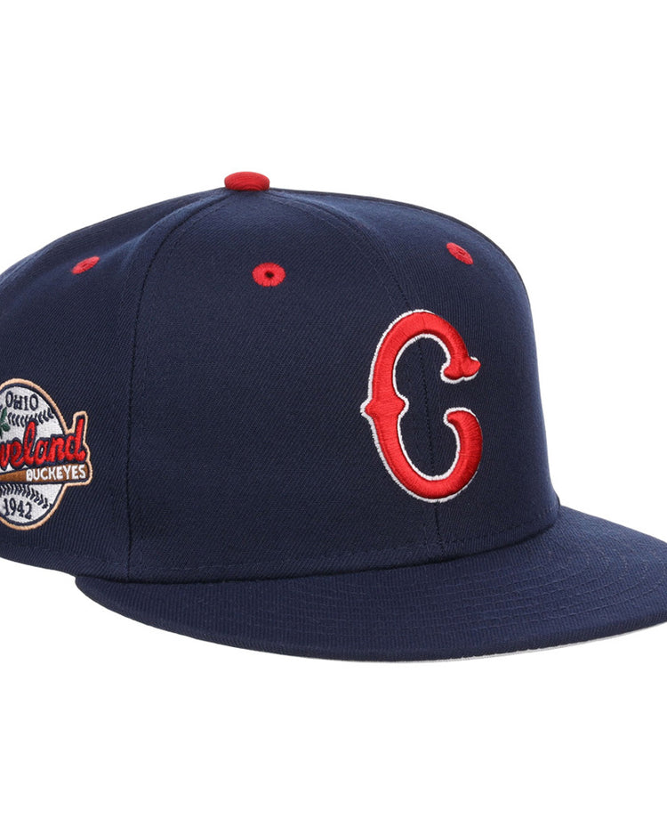 The Cleveland Buckeyes NLB Varsity Fitted Ballcap by Ebbets Field features a navy blue design with a red and white C logo, side patch reading 