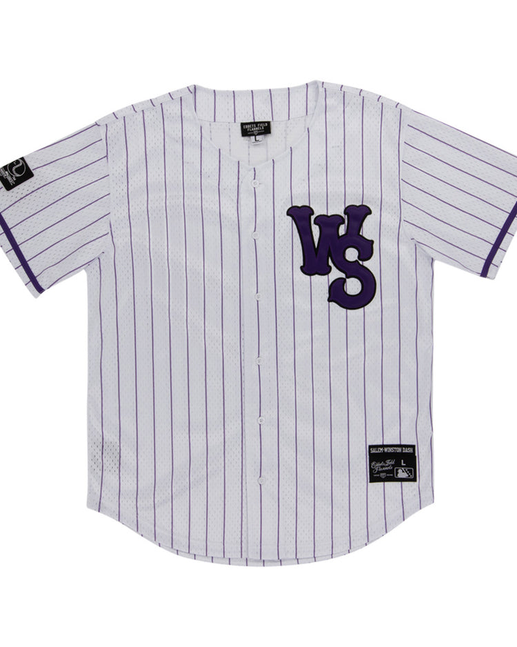 The Ebbets Field Winston-Salem Dash MiLB Button Down Jersey is a white jersey with thin purple stripes, bold purple WS letters on the left chest, and black label patches on the right sleeve and lower left front.