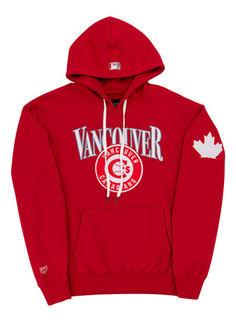 The Ebbets Field Vancouver Canadians MiLB Cotton Hooded Sweatshirt features red fabric, “Vancouver” and “Canadians” on the chest, a maple leaf on the left sleeve, white drawstrings, and a front pocket.