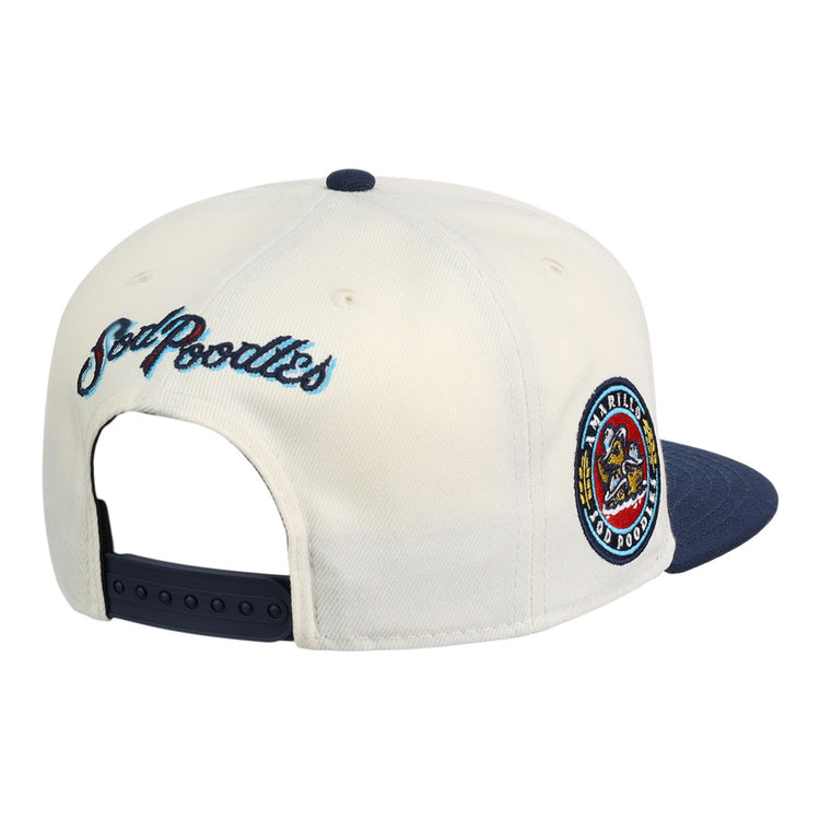 The Ebbets Field Amarillo Sod Poodles MiLB Snapback Ballcap features a white/navy design, colorful circular team patch on the side, 