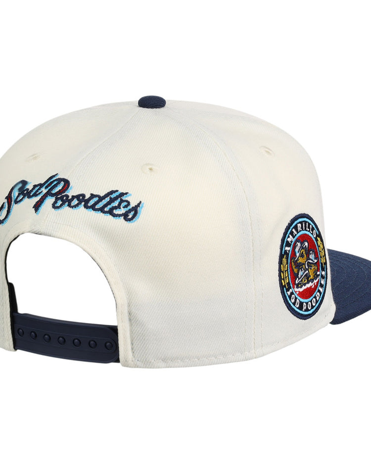 The Ebbets Field Amarillo Sod Poodles MiLB Snapback Ballcap features a white/navy design, colorful circular team patch on the side, 