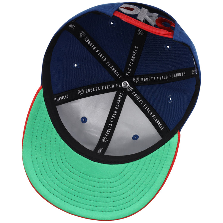 The underside of the Oklahoma City Dodgers MiLB Two Tone Snapback Ballcap by Ebbets Field features a green brim, black inner seams labeled EBBETS FIELD FLANNELS, blue inner panels, and a red edge around the brim.