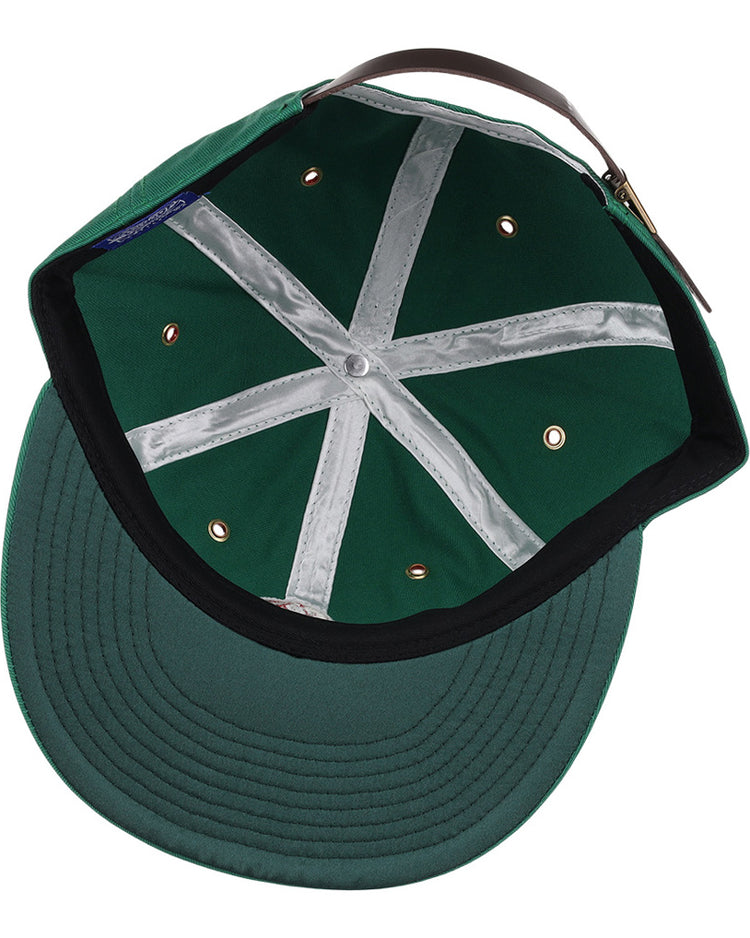 The Ebbets Field Hot Spring Bathers MiLB Cotton Ballcap features a green design with white X-pattern seam tape, metal eyelets, a black sweatband, and an adjustable brown leather strap viewed from the inside.