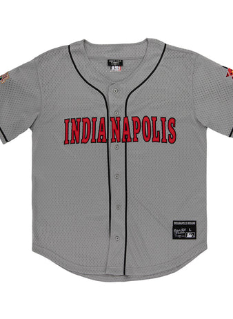 The Ebbets Field Indianapolis Indians MiLB Button Down Jersey is gray with black trim, bold red INDIANAPOLIS lettering on the chest, sleeve patches, and visible tags by the collar and bottom hem.