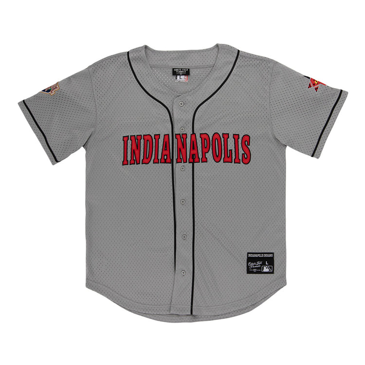 The Ebbets Field Indianapolis Indians MiLB Button Down Jersey is gray with black trim, bold red INDIANAPOLIS lettering on the chest, sleeve patches, and visible tags by the collar and bottom hem.